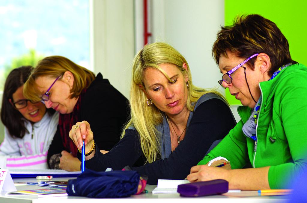 Professional consultation team reviewing digital blueprints and technical specifications on modern displays