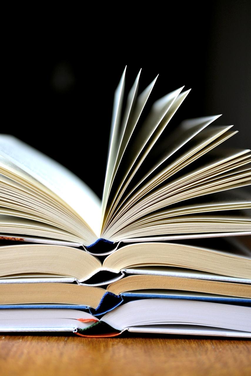 Open book and digital tablet representing comprehensive learning guides